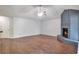 Bright living room featuring hardwood floors, a painted brick fireplace, and lots of natural light at 814 Arbor Hill Dr, Stone Mountain, GA 30088