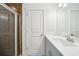 Well-lit bathroom features a modern vanity, white door, and tiled walk-in shower at 221 Semel Nw Cir # 245, Atlanta, GA 30309