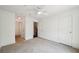 Spacious bedroom with neutral carpet, a ceiling fan, and ample closet space at 221 Semel Nw Cir # 245, Atlanta, GA 30309