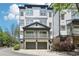 Charming townhome with a two-car garage, upper balcony, neutral paint, and manicured landscaping at 221 Semel Nw Cir # 245, Atlanta, GA 30309