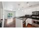 Open concept kitchen with stainless steel appliances and dark granite countertops overlooking the living area at 221 Semel Nw Cir # 245, Atlanta, GA 30309