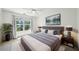 Serene main bedroom featuring a large window, a ceiling fan, and stylish decor at 221 Semel Nw Cir # 245, Atlanta, GA 30309