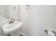 Cozy powder room featuring a pedestal sink, a round mirror, and modern fixtures at 221 Semel Nw Cir # 245, Atlanta, GA 30309