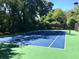 Well-maintained tennis court surrounded by lush green trees providing a private setting at 221 Semel Nw Cir # 245, Atlanta, GA 30309