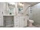 Bright bathroom features white vanity, and shower behind sliding glass door with tiled walls at 300 Peachtree Ne St # 5A, Atlanta, GA 30308