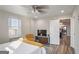 Well-lit bedroom includes ceiling fan, hardwood floors, television and stylish furnishings and access to the kitchen at 300 Peachtree Ne St # 5A, Atlanta, GA 30308