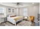 Cozy bedroom with lots of natural light features ceiling fan, hardwood floors, and stylish furnishings at 300 Peachtree Ne St # 5A, Atlanta, GA 30308