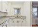 Corner kitchen featuring granite countertops and white cabinetry at 300 Peachtree Ne St # 5A, Atlanta, GA 30308