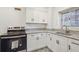 Modern kitchen with white cabinets, granite countertops, and stainless steel appliances at 300 Peachtree Ne St # 5A, Atlanta, GA 30308