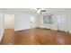 Spacious living room with hardwood floors, ceiling fan, and a view into the kitchen at 300 Peachtree Ne St # 5A, Atlanta, GA 30308