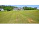 View of a large grassy backyard with a single-Gathering home in the background at 330 Pitts Chapel Rd, Newborn, GA 30056