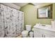 Bathroom featuring a mirror, toilet, and shower with Paris themed curtain at 330 Pitts Chapel Rd, Newborn, GA 30056