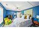 Inviting bedroom with blue accent walls, and ceiling fan, creating a cozy retreat at 330 Pitts Chapel Rd, Newborn, GA 30056