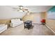 Bonus room with carpeted floor, two ceiling fans, white leather sofa, and foosball table at 330 Pitts Chapel Rd, Newborn, GA 30056
