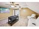 Bonus room with carpeted floor, two ceiling fans, white leather sofa, and foosball table at 330 Pitts Chapel Rd, Newborn, GA 30056