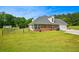 Single story brick home featuring an attached garage, fenced backyard, and lush green grass at 330 Pitts Chapel Rd, Newborn, GA 30056