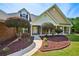 A well-kept brick home featuring mature landscaping and covered entryway at 330 Pitts Chapel Rd, Newborn, GA 30056