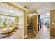 Bright foyer featuring a staircase, seating area with a yellow chair and a view into the kitchen at 330 Pitts Chapel Rd, Newborn, GA 30056