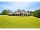Beautiful single story brick home with attached garage, and sprawling green lawn at 330 Pitts Chapel Rd, Newborn, GA 30056