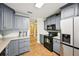 Kitchen with gray cabinets, stainless steel appliances, and easy access at 330 Pitts Chapel Rd, Newborn, GA 30056