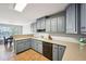Kitchen featuring gray cabinets, ample counter space, dishwasher, and tile flooring at 330 Pitts Chapel Rd, Newborn, GA 30056
