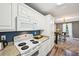 Charming kitchen with white appliances, sleek countertops, and ample cabinet space at 330 Pitts Chapel Rd, Newborn, GA 30056