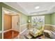 Comfortable living room area with a yellow chair, bright window and a tray ceiling at 330 Pitts Chapel Rd, Newborn, GA 30056