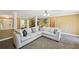 Spacious living room with plush sectional sofa, neutral walls, and modern ceiling fan at 330 Pitts Chapel Rd, Newborn, GA 30056