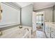 Bright bathroom with a soaking tub and a view to the connected bedroom at 330 Pitts Chapel Rd, Newborn, GA 30056