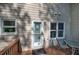 Backyard deck featuring a table and chairs with a view of a lush, wooded area and door to enter home at 3945 Lorien Way, Kennesaw, GA 30152