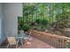 Backyard deck featuring a table and chairs with a view of a lush, wooded area at 3945 Lorien Way, Kennesaw, GA 30152