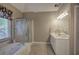 Neutral-colored bathroom featuring double sinks, a jacuzzi tub, and a glass-door shower at 3945 Lorien Way, Kennesaw, GA 30152