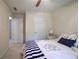 Bedroom featuring a bed with a blue-and-white comforter, neutral walls, and two doors at 3945 Lorien Way, Kennesaw, GA 30152