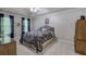 Carpeted bedroom with large window, tray ceiling, and matching furniture set at 3945 Lorien Way, Kennesaw, GA 30152