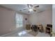 Bedroom features a ceiling fan, neutral walls, window with blinds, and space for a desk setup at 3945 Lorien Way, Kennesaw, GA 30152