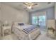 Bedroom with a white bedspread, blue accents, and a window with sheer curtains at 3945 Lorien Way, Kennesaw, GA 30152