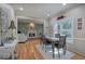 Dining room with hardwood floors, fireplace, large window with backyard view and access to the living room at 3945 Lorien Way, Kennesaw, GA 30152