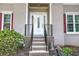 Front porch with a decorative door and trimmed bushes around the railing at 3945 Lorien Way, Kennesaw, GA 30152