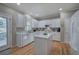 All-white kitchen featuring an island, modern appliances, and hardwood floors at 3945 Lorien Way, Kennesaw, GA 30152