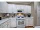 Functional kitchen offering white cabinetry, appliances, and ample counter space at 3945 Lorien Way, Kennesaw, GA 30152