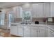 White kitchen featuring a sink with a window, appliances, and neutral countertops at 3945 Lorien Way, Kennesaw, GA 30152