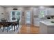 Bright kitchen and dining area with white cabinets, large windows and access to backyard deck at 3945 Lorien Way, Kennesaw, GA 30152