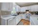 Well-lit kitchen with white cabinets, stainless steel appliances, and hardwood flooring at 3945 Lorien Way, Kennesaw, GA 30152