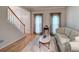 Bright living room with hardwood floors, plush sofa and adjacent staircase at 3945 Lorien Way, Kennesaw, GA 30152
