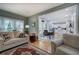 Bright living room showcasing a view into the dining and kitchen areas with hardwood floors at 3945 Lorien Way, Kennesaw, GA 30152