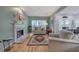Inviting living room featuring a fireplace with a marble surround and beautiful hardwood floors at 3945 Lorien Way, Kennesaw, GA 30152