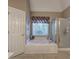 Main bathroom with jacuzzi tub, shower cabin, and window at 3945 Lorien Way, Kennesaw, GA 30152