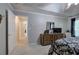 Main bedroom featuring carpet, dresser, TV, tray ceiling, and access to other rooms at 3945 Lorien Way, Kennesaw, GA 30152