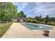 Community pool covered for the off-season, surrounded by trees, a fence, and a covered seating area at 3945 Lorien Way, Kennesaw, GA 30152