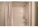 Shower tub with showerhead with grey and white striped curtain at 3945 Lorien Way, Kennesaw, GA 30152